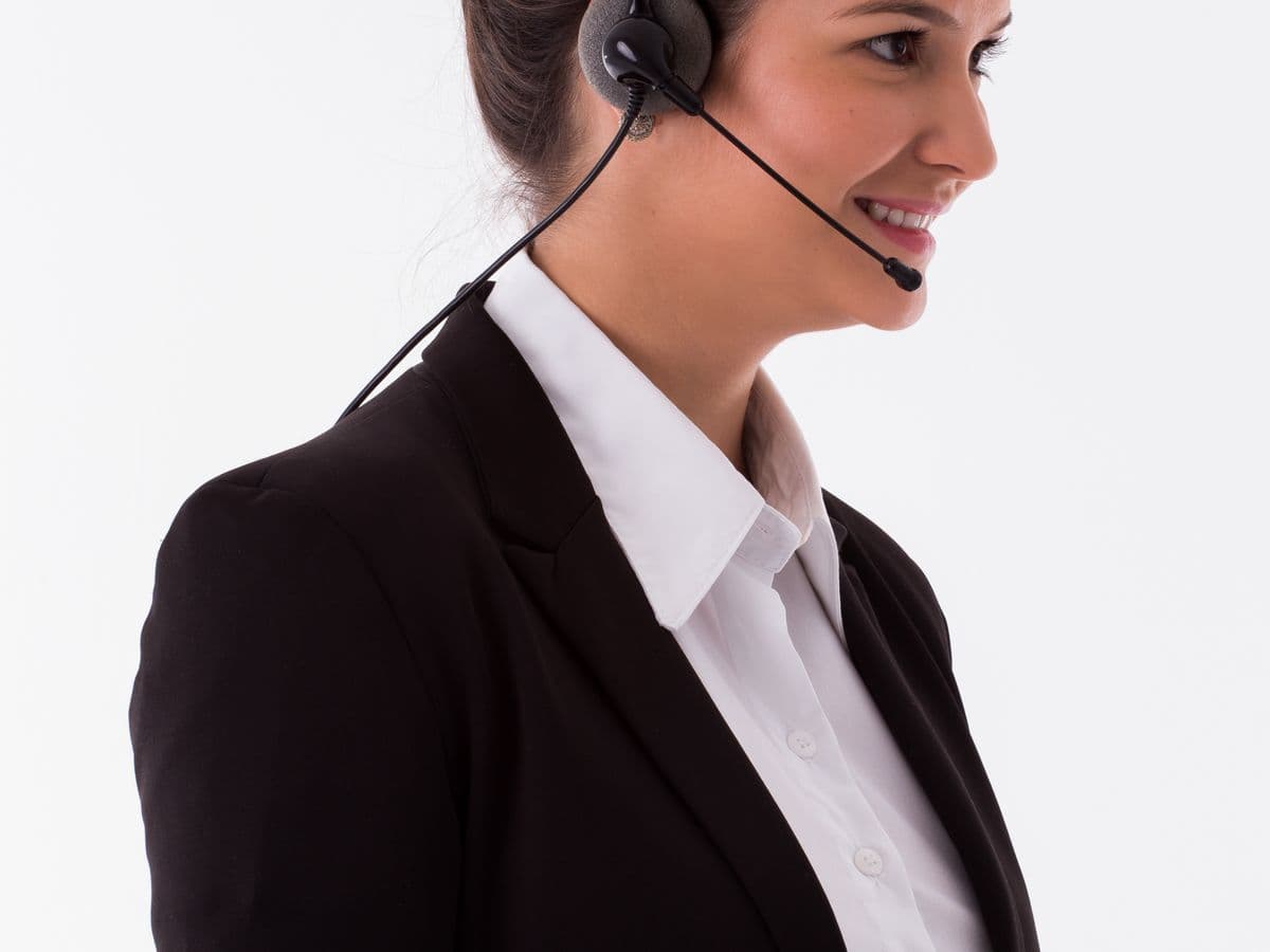 A friendly professional wearing a headset, ready to help on a call