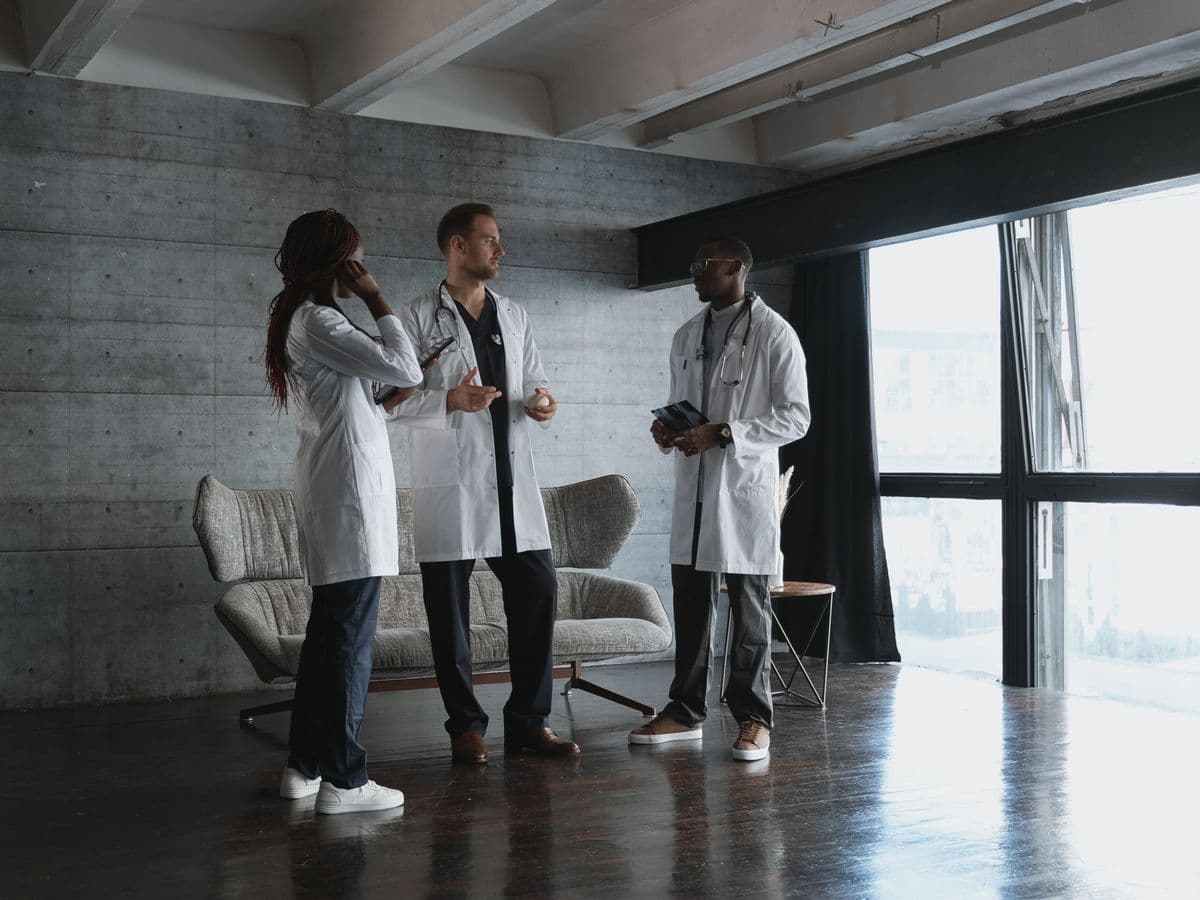 Physicians in white coats discussing a case together