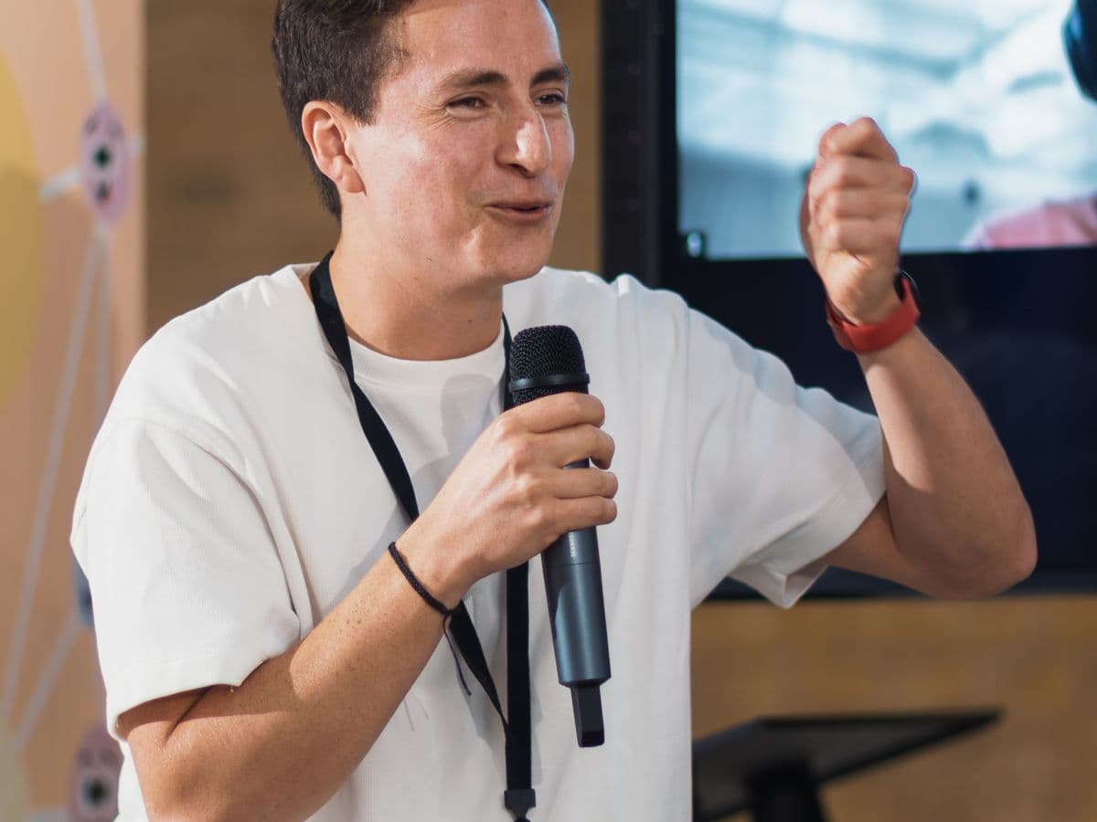 A researcher presenting findings to an audience with a microphone