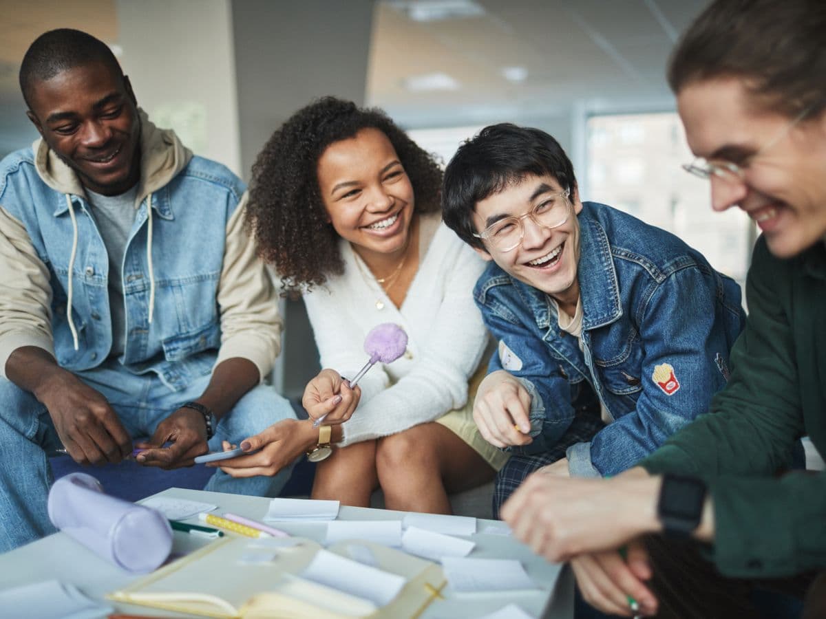 A diverse group of students studying and talking together