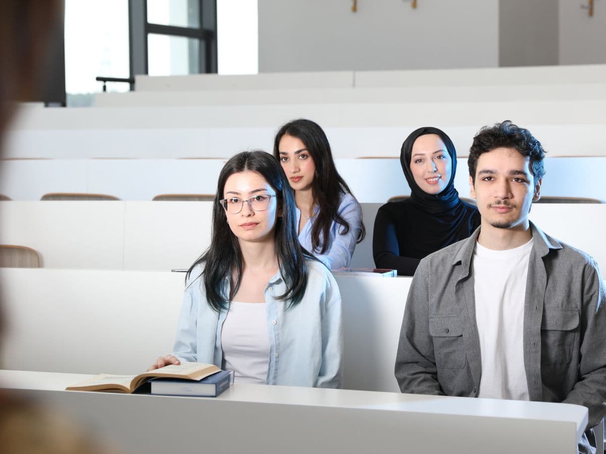 Diverse university students in a bright modern lecture hall